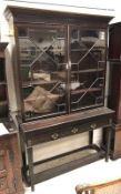 A 19th Century mahogany bookcase cabinet with astragal-glazed doors enclosing adjustable shelving,