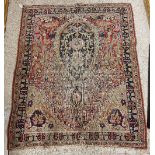 A Kirman prayer rug, the central panel set with foliate decorated medallion on a red ground,