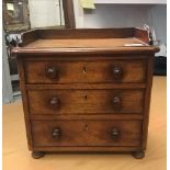 A Victorian mahogany miniature dressing chest of three long drawers