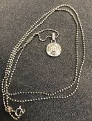 A 9 carat white gold and diamond set pendant of medallion form