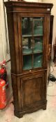 A 20th Century walnut veneered free-standing corner cupboard in the 18th Century manner,