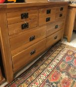 A modern oak chest of three short over four longer drawers,