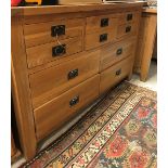 A modern oak chest of three short over four longer drawers,