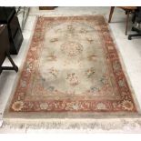 A Chinese superwash carpet, the central panel set with floral sprays on a mushroom ground,