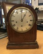 A circa 1900 oak dome cased mantel clock,