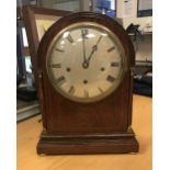 A circa 1900 oak dome cased mantel clock,