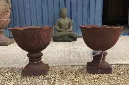 A pair of modern cast iron garden urns of foliate design