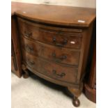 A mid 20th Century bow fronted burr walnut chest with brushing slide over three drawers on cabriole