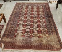 A Bokhara style rug, the central panel set with repeating medallions on a red ground,