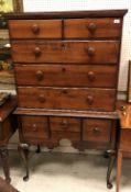 A 19th Century American maplewood tallboy chest on chest the upper section with two short over