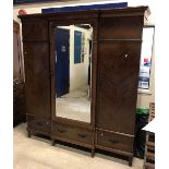 A Waring & Gillow of Lancaster mahogany break-front wardrobe with central mirror door enclosing