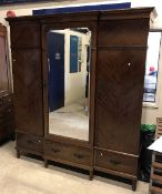 A Waring & Gillow of Lancaster mahogany break-front wardrobe with central mirror door enclosing