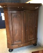 A 19th Century Dutch oak kas of typical form with canted sides opening to reveal three shelves over