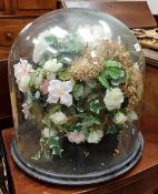 A glass dome on ebonised base containing a silk flower floral arrangement CONDITION