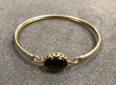 A 9 carat gold set stone bangle