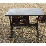 A cast iron table stand with marble top