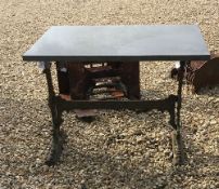 A cast iron table stand with marble top