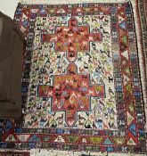 A Kelim rug, the central panel set with two stylised cross medallions on a red and cream ground,