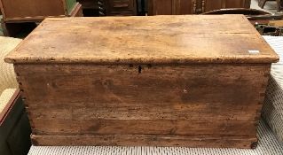 A Victorian pine trunk of plain form with iron carrying handles