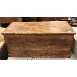 A Victorian pine trunk of plain form with iron carrying handles