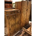 An early to mid 20th Century walnut two door wardrobe and similar bedroom cabinet of two drawer