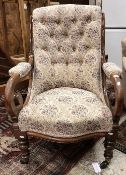 A Victorian walnut framed button back open arm salon chair with ornate scroll arms and serpentine