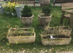 A collection of four concrete troughs together with two concrete urns