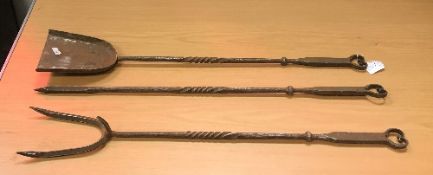 A set of three steel fire tools in the Arts and Crafts manner comprising shovel, poker and fork,