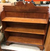 A late Victorian mahogany three tier open bookcase on bracket feet