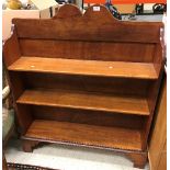 A late Victorian mahogany three tier open bookcase on bracket feet