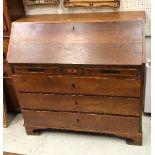 A George IV oak and inlaid bureau as a marriage piece the plain top over a sloping fall enclosing a