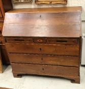 A George IV oak and inlaid bureau as a marriage piece the plain top over a sloping fall enclosing a