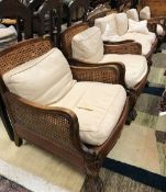 An early to mid 20th Century stained beech framed Bergere five piece suite comprising two seat sofa