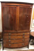 A mahogany bow fronted linen press,