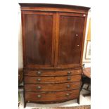 A mahogany bow fronted linen press,