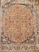 Two Persian style table covers, each with floral decoration, one on an orange ground,