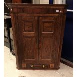 A 19th Century oak and inlaid two door hanging corner cupboard with drawer flanked by two dummy