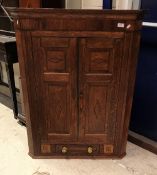 A 19th Century oak and inlaid two door hanging corner cupboard with drawer flanked by two dummy