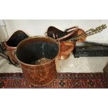 Two copper coal helmets and a copper log bucket together with three brass fire tools and a pair of