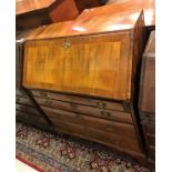 An 18th Century walnut bureau the cross-