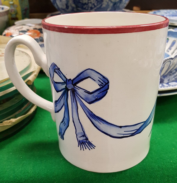 A Wemyss "Blue Bow" decorated quart mug