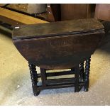 A 19th Century oak gate leg table on bar