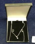 A diamond pendant and earring set