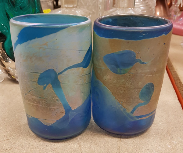 A pair of iridescent blue glass vases in