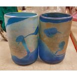 A pair of iridescent blue glass vases in