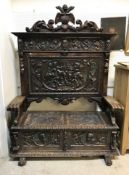 A carved painted and gilded walnut settl