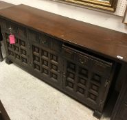 A modern oak sideboard dresser with plain top over three drawers and three panelled cupboard doors