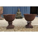 A pair of modern cast iron garden urns o