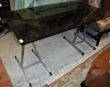 A smoked glass topped centre table on ch