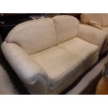 A cream floral upholstered two seat sofa